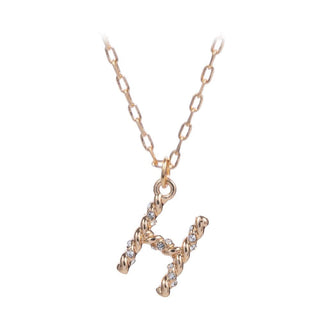 short metal necklace with textured “H” letter pendant