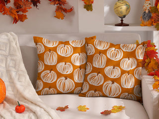 square orange pillows with white striped pumpkins
